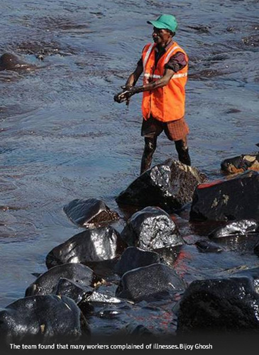 Fisherman cleaning up oil spill