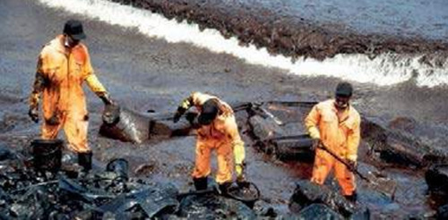 Fisherman cleaning up oil spill