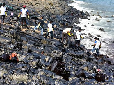 Fisherman cleaning up oil spill