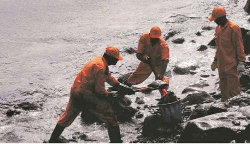 Fisherman cleaning up oil spill